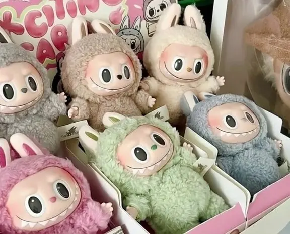 Labubu doll from Popmart next to surprise blind box packaging